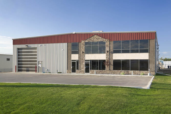 Commercial building exterior with white and red metal panels